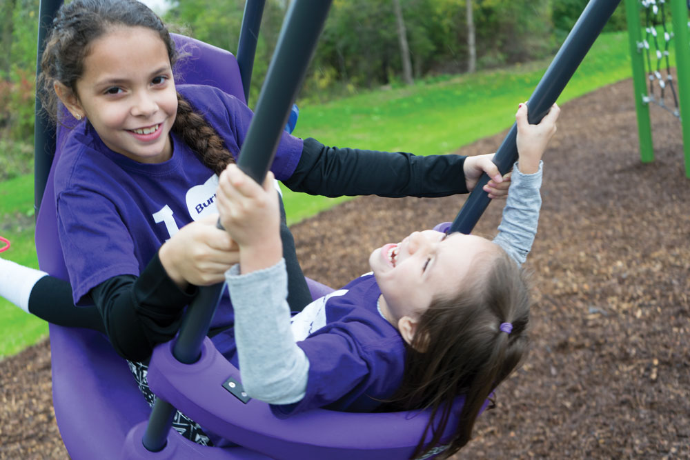 children playing in tandem swing